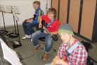 Guitars and seating in clean, bright studio.
